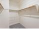 Empty walk-in closet featuring both wire and wooden shelving, and hanging rods at 38065 N Cave Creek Rd # 52, Cave Creek, AZ 85331