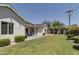 Expansive backyard with lush lawn, covered patio, and charming landscaping at 3813 N 37Th St, Phoenix, AZ 85018