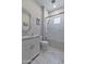 Well-lit bathroom showcasing marble floors, granite counter vanity, and modern shower with glass doors at 3813 N 37Th St, Phoenix, AZ 85018