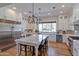 Spacious white kitchen with a large marble island, stainless steel appliances, and hardwood floors at 3813 N 37Th St, Phoenix, AZ 85018