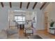 Open-concept living area with hardwood floors, seamlessly connecting to the bright, white kitchen at 3813 N 37Th St, Phoenix, AZ 85018
