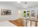 Bright bedroom with hardwood floors, modern art, and French doors to the outdoor living space at 3817 E Highland Ave, Phoenix, AZ 85018