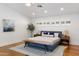 Serene bedroom with hardwood floors, minimalist decor, and natural light at 3817 E Highland Ave, Phoenix, AZ 85018