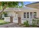 Charming front exterior featuring a white picket fence, brick accents, and a well-manicured lawn at 3817 E Highland Ave, Phoenix, AZ 85018