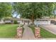 Charming home with a brick pathway, lush lawn, mature trees, and a classic white picket fence at 3817 E Highland Ave, Phoenix, AZ 85018