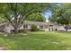 Beautifully landscaped home with lush green lawn, mature trees, and a charming white picket fence at 3817 E Highland Ave, Phoenix, AZ 85018