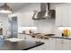 Modern kitchen with stainless steel appliances, white cabinets, and granite countertops at 3817 E Highland Ave, Phoenix, AZ 85018