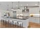 Contemporary kitchen with a large island, stainless steel appliances, and stylish pendant lighting at 3817 E Highland Ave, Phoenix, AZ 85018