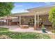 Outdoor patio with an outdoor kitchen, a grill, a fire pit, and lush greenery for a perfect outdoor retreat at 3817 E Highland Ave, Phoenix, AZ 85018