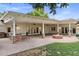Expansive covered outdoor patio featuring a fire pit and an outdoor kitchen, perfect for entertaining at 3817 E Highland Ave, Phoenix, AZ 85018