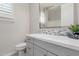 Bathroom featuring a modern vanity with white countertop, mosaic backsplash, and a large mirror at 3892 E Harrison St, Gilbert, AZ 85295