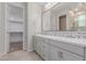 Bathroom vanity with dual sinks, modern faucets, decorative mirrors, and tile backsplash at 3892 E Harrison St, Gilbert, AZ 85295