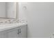 Bathroom vanity featuring quartz countertops, modern faucet, tile backsplash, and decorative mirror at 3892 E Harrison St, Gilbert, AZ 85295