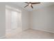 This bedroom offers neutral walls, tile floors, ceiling fan, and an entrance to a private space at 3892 E Harrison St, Gilbert, AZ 85295