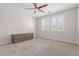 Neutral bedroom featuring a ceiling fan, shuttered windows and carpet at 3892 E Harrison St, Gilbert, AZ 85295