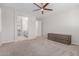 Spacious carpeted bedroom featuring a ceiling fan and ensuite bathroom at 3892 E Harrison St, Gilbert, AZ 85295