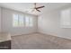 Bright bedroom featuring neutral carpet, ceiling fan, and shuttered windows allowing ample natural light at 3892 E Harrison St, Gilbert, AZ 85295