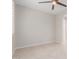This bedroom features neutral walls, a ceiling fan, and beige tile flooring, offering a serene and comfortable space at 3892 E Harrison St, Gilbert, AZ 85295