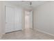 Bright bedroom featuring tile flooring and a closet with sliding doors for ample storage space at 3892 E Harrison St, Gilbert, AZ 85295