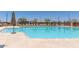Large community pool surrounded by lounge chairs and umbrellas, offering a perfect spot for relaxation at 3892 E Harrison St, Gilbert, AZ 85295