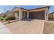 Beautiful home exterior featuring a brick driveway, a two-car garage, and a well maintained front yard at 3892 E Harrison St, Gilbert, AZ 85295