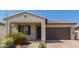 Charming single-story home featuring a tile roof, brick driveway, and tidy landscaping with red flowering shrubs at 3892 E Harrison St, Gilbert, AZ 85295