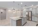 Modern kitchen with stainless appliances, gray cabinets, an island with a sink, and granite countertops at 3892 E Harrison St, Gilbert, AZ 85295