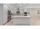 Bright kitchen featuring an island with pendant lighting, gray cabinets, and stainless steel refrigerator at 3892 E Harrison St, Gilbert, AZ 85295