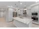 Modern kitchen featuring a large island with a sink, stainless steel appliances, and ample cabinet space at 3892 E Harrison St, Gilbert, AZ 85295