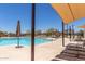 Relaxing community pool with lounge chairs and sun shades for residents enjoyment and comfort at 3892 E Harrison St, Gilbert, AZ 85295