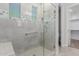 Modern tiled shower with glass door, a bench, and decorative tile detail at 3892 E Harrison St, Gilbert, AZ 85295