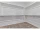 Walk-in closet with white shelving, metal rods, and neutral carpet at 3892 E Harrison St, Gilbert, AZ 85295
