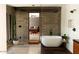 Modern bathroom featuring a freestanding tub, elegant tile work, and stylish fixtures at 4032 N 45Th Pl, Phoenix, AZ 85018