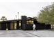 Striking modern home with sleek, dark exterior, complemented by desert landscaping and a minimalist design at 4032 N 45Th Pl, Phoenix, AZ 85018