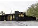 Modern home featuring a distinctive black exterior, unique brick fence, and a beautifully landscaped yard at 4032 N 45Th Pl, Phoenix, AZ 85018