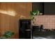 Stylish kitchen featuring a sleek black refrigerator and pink tiled backsplash at 4032 N 45Th Pl, Phoenix, AZ 85018