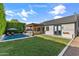 Spacious backyard with a pool, patio with pergola, lush lawn and green hedges at 4132 N 42Nd St, Phoenix, AZ 85018