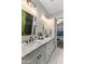 Bright bathroom with a double sink, marble countertops, and a walk-in shower at 4132 N 42Nd St, Phoenix, AZ 85018
