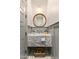 Stylish powder room featuring a marble floating vanity with a round mirror and unique lighting at 4132 N 42Nd St, Phoenix, AZ 85018