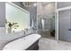 Elegant bathroom featuring a soaking tub, glass shower, and modern tile work at 4132 N 42Nd St, Phoenix, AZ 85018