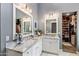 Stylish bathroom with marble countertops, dual sinks, and a walk-in closet at 4132 N 42Nd St, Phoenix, AZ 85018