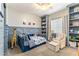 Charming bedroom with unique decor, built-in shelves, and a cozy seating area at 4132 N 42Nd St, Phoenix, AZ 85018