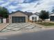 Charming home boasts a modern garage door, patterned driveway, and well-maintained landscaping at 4132 N 42Nd St, Phoenix, AZ 85018