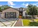 Charming single-story home with brick accents, a glass-paned garage door and modern desert landscaping at 4132 N 42Nd St, Phoenix, AZ 85018