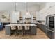 Bright kitchen featuring an island with seating, pendant lights, and stainless steel appliances at 4132 N 42Nd St, Phoenix, AZ 85018