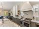 Gourmet kitchen features a professional range, marble countertops, and custom cabinetry at 4132 N 42Nd St, Phoenix, AZ 85018