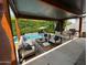 Stylish covered patio featuring a cozy lounge area, dining set, and refreshing pool for outdoor enjoyment at 4132 N 42Nd St, Phoenix, AZ 85018