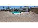 Backyard with a covered patio, beautiful pool, and low maintenance gravel landscaping at 4234 E Winnetka Dr, Phoenix, AZ 85044