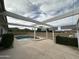 Relaxing backyard featuring a pool, spa, and patio with a shade structure set against a backdrop of natural desert landscape at 4234 E Winnetka Dr, Phoenix, AZ 85044