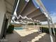 Inviting backyard featuring a refreshing pool, spa, custom shade structure, and well-maintained landscaping at 4234 E Winnetka Dr, Phoenix, AZ 85044